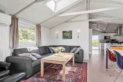 a living room with a couch and a table at LK504-Lokken-Kristavej-23 in Løkken