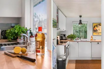 a kitchen with a bottle of whiskey and lemons on a counter at BL339-Pandrup-Skorr-Karensvej-5 in Pandrup