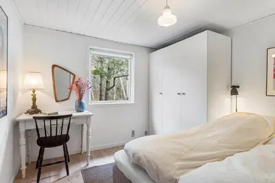 a bedroom with a bed and a desk and a window at BL339-Pandrup-Skorr-Karensvej-5 in Pandrup