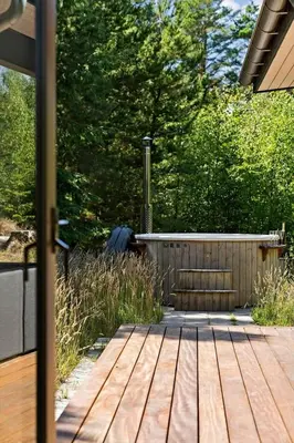 a wooden deck in a yard with a fence at BL1535-Blokhus-Saetergaardsstien-5-A in Blokhus