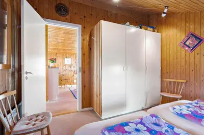 a room with a large white cabinet and a bedroom at LK1947-Lokken-Madsinesvej-11 in Løkken
