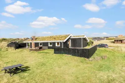 a house with a grass roof on top of a field at LK1947-Lokken-Madsinesvej-11 in Løkken