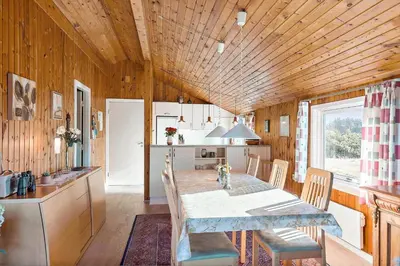 a kitchen and dining room with a table and chairs at LK1947-Lokken-Madsinesvej-11 in Løkken