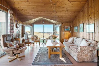 a living room with a couch and chairs and a table at LK1947-Lokken-Madsinesvej-11 in Løkken