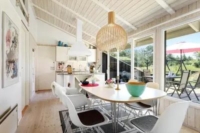 a kitchen and dining room with a table and chairs at BL102-Saltum-Kvansletten-13 in Saltum