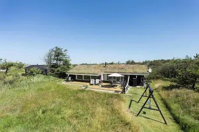 a house with a grass roof on a field at BL102-Saltum-Kvansletten-13 in Saltum