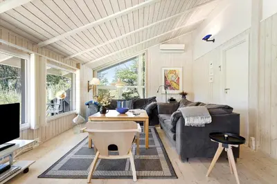 a living room with a couch and a table at BL102-Saltum-Kvansletten-13 in Saltum