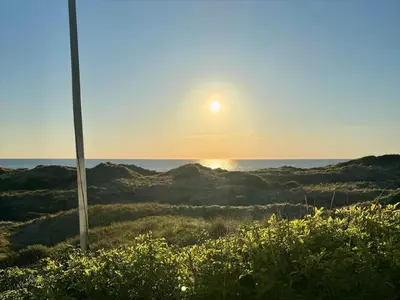 a view of the ocean with the sun in the sky at LK1990-Lokken-Lottesvej-27 in Løkken