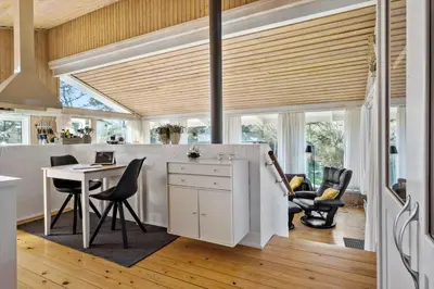 a kitchen with a table and chairs and a dining room at BL124-Blokhus-Klitvejen-75-a in Blokhus