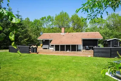 a house with a red roof and a yard at BL1402-Blokhus-Bag-Hojen-57 in Blokhus