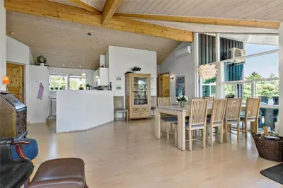 a kitchen and dining room with a table and chairs at LK1813-Lokken-Jorginesvej-3 in Løkken