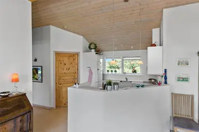 a kitchen with white cabinets and a counter top at LK1813-Lokken-Jorginesvej-3 in Løkken