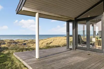 a porch of a house with a view of the ocean at LK611-Lokken-Rosavej-9 in Løkken