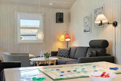 a living room with a couch and a table at BL368-Blokhus-Bag-Hojen-19 in Blokhus