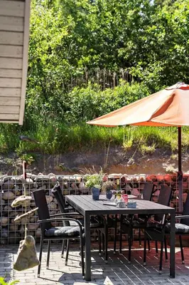 a table with an umbrella on a patio at BL368-Blokhus-Bag-Hojen-19 in Blokhus