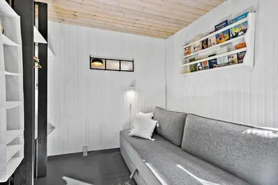 a living room with a gray couch in a room at BL1789-Saltum-Krogsletten-20 in Saltum