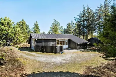 a small house in the middle of a forest at BL1789-Saltum-Krogsletten-20 in Saltum
