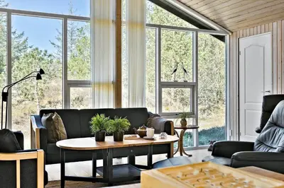 a living room with a couch and a table at BL1789-Saltum-Krogsletten-20 in Saltum