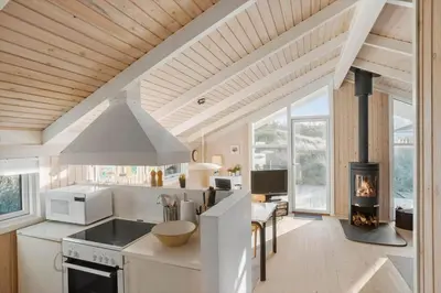 a kitchen with a stove and a fireplace at BL1414-Saltum-Porsevej-18-A in Saltum