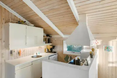 a kitchen with white cabinets and a white hood at BL1414-Saltum-Porsevej-18-A in Saltum
