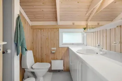 a bathroom with a white toilet and a sink at BL1414-Saltum-Porsevej-18-A in Saltum