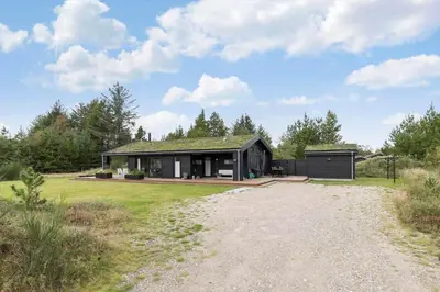 a house with a gravel road in front of it at BL1635-Blokhus-Lyngdraget-19 in Blokhus