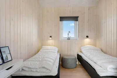 two beds in a room with a window at LK2031-Lokken-Kringelbaekvej-55 in Løkken