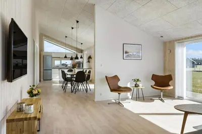 a living room with chairs and a dining room at LK2031-Lokken-Kringelbaekvej-55 in Løkken
