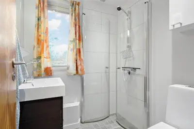 a white bathroom with a shower and a sink at BL128-Saltum-Klaus-Bjergsvej-9 in Saltum