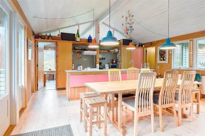 a kitchen and dining room with a wooden table and chairs at BL128-Saltum-Klaus-Bjergsvej-9 in Saltum