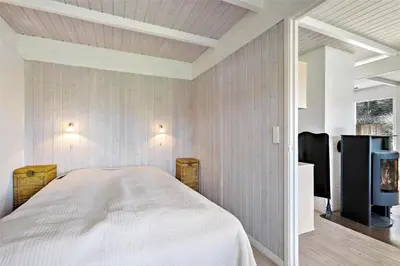 a bedroom with a bed and a tv in it at BL116-Saltum-Revlingevej-44 in Saltum
