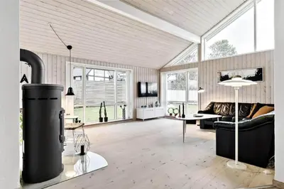 a living room with a couch and a table at BL1629-Blokhus-Klitgaardsvej-29 in Blokhus