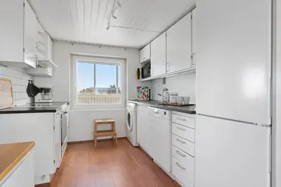 a kitchen with white appliances and a window at LK2130-Lokken-Lottesvej-23 in Løkken