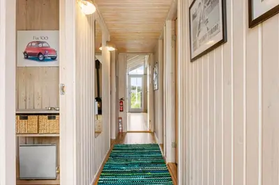 a hallway with a green rug on the floor at BL416-Saltum-Revlingevej-28 in Saltum