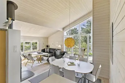 a living room with a table and chairs at BL547-Blokhus-Skraavejen-8 in Blokhus