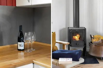 a room with a bottle of wine and a wood stove at LK2117-Lokken-Kettrup-Bjerge-Vej-55 in Løkken