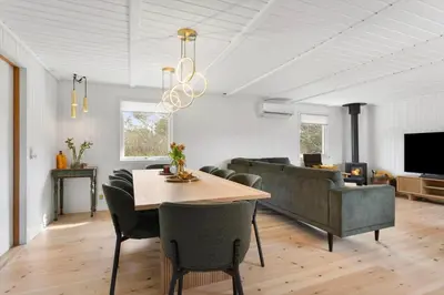 a living room with a table and a couch at LK2117-Lokken-Kettrup-Bjerge-Vej-55 in Løkken