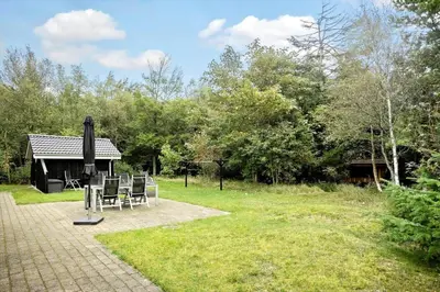 a group of chairs sitting in a yard at BL1764-Pandrup-Lunekrogen-7 in Pandrup