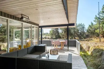 a screened in porch with a couch and a table at BL1131-Saltum-Daadyrvej-11 in Saltum
