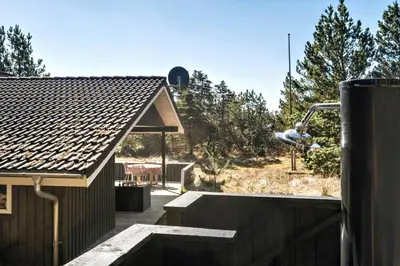 a backyard of a house with a deck and a house at BL1131-Saltum-Daadyrvej-11 in Saltum