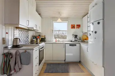 a kitchen with white appliances and a window at BL771-Saltum-Egernvej-36 in Saltum