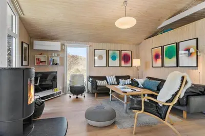 a living room with a couch and a fireplace at BL771-Saltum-Egernvej-36 in Saltum
