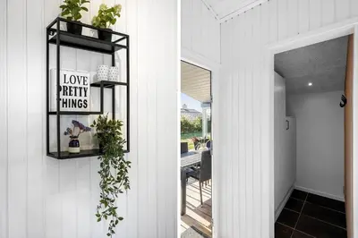 a hallway of a house with a mirror and a table at LK2141-Lokken-Kristavej-15 in Løkken