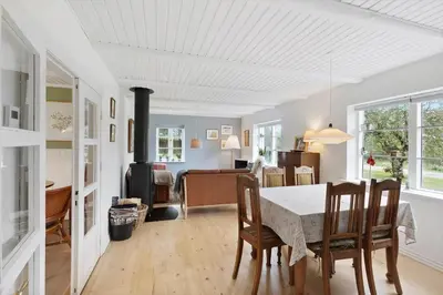 a kitchen and dining room with a table and chairs at BL367-Pandrup-Rodhus-Kirkevej-5 in Pandrup