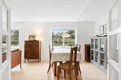 a dining room with a table and chairs at BL367-Pandrup-Rodhus-Kirkevej-5 in Pandrup