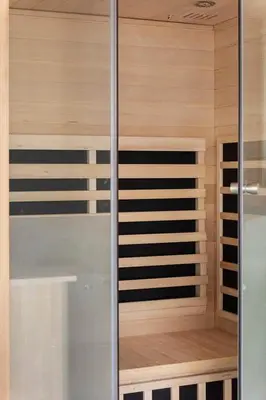 a sauna with wooden walls and a glass door at LK2143-Lokken-Kringelbaekvej-29 in Løkken