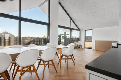 a kitchen and dining room with a table and chairs at LK2143-Lokken-Kringelbaekvej-29 in Løkken