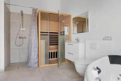 a bathroom with a shower and a toilet and a sink at LK2143-Lokken-Kringelbaekvej-29 in Løkken