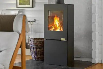a fireplace with a fire in it in a living room at BL1363-Blokhus-Fiskene-7 in Blokhus