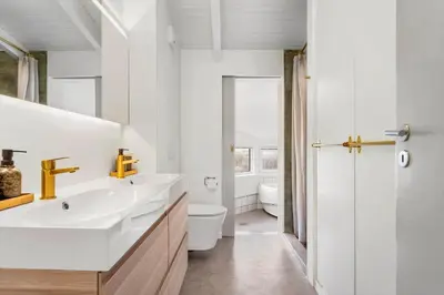 a white bathroom with a sink and a toilet at LK2126-Lokken-Jorginesvej-4 in Løkken